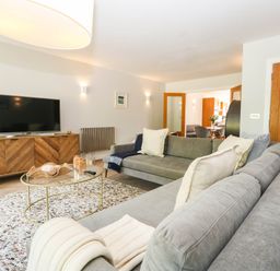A living room with a sofa and television at Harbour Heights in Weymouth