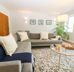 A living room with a sofa and coffee table at Harbour Heights in Weymouth