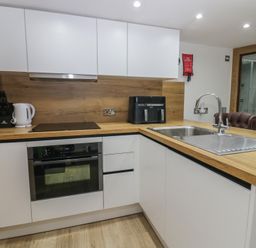 A kitchen with appliances and wood finish countertops at Park View Studio in Ambleside
