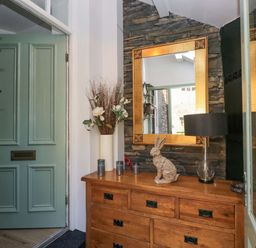 An entryway with a door and chest of drawers at Park View in Ambleside