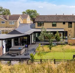 An outdoor area with a hot tub and deck at Manor Farm House in Merton near Bicester