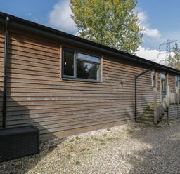 A building exterior with windows and a staircase at Willow Cottage in Whiteparish
