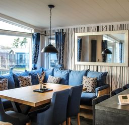 A living room with a sofa and dining table at Hotchkin Lodge in Woodhall Spa