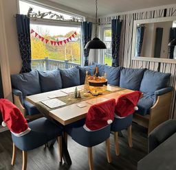 A dining room with a table set for decoration at Hotchkin Lodge in Woodhall Spa