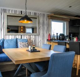 A dining room with a table and chairs at Hotchkin Lodge in Woodhall Spa