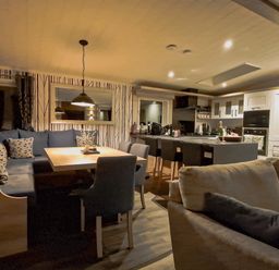 A kitchen with a dining table and chairs at Hotchkin Lodge in Woodhall Spa