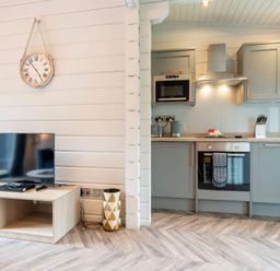 A kitchen with television, cabinets, microwave and stove at Askrigg in Aysgarth