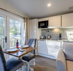 A kitchen with a dining area and kitchen appliances at Somersby (Pet) Louth