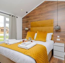 A bedroom with a bed and window at The Woodnewton in Wansford