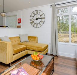A living room with a sofa, coffee table and fruit bowl at The Woodnewton in Wansford