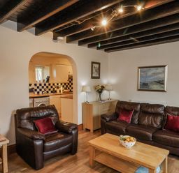 A living room with sofas and a coffee table at 2 High Stakesby Cottages in Whitby