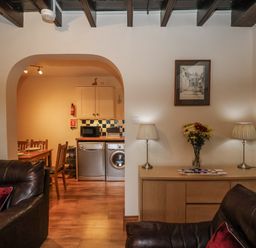 A living room with a view into the kitchen at 2 High Stakesby Cottages in Whitby