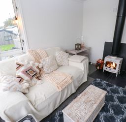 A living room with a couch and fireplace at John's Folly