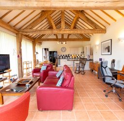 A living room with a television and sofa at Nature's Lodge in Cookley