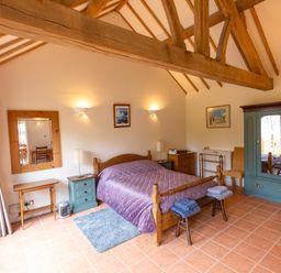 A bedroom with a bed and wardrobe at Nature's Lodge in Cookley
