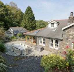 An outdoor space with a patio and dining set at Bobbin Mill Cottage in Ulverston