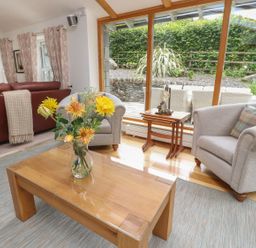 A living room with a sofa and armchair at Bobbin Mill Cottage Ulverston