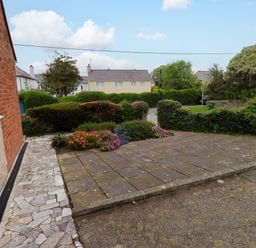 An outdoor area with paving stones and flowers at Gelli - Morfa Nefyn in Morfa Nefyn