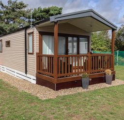 A caravan with a deck and planters at Stag Lodge, Caravan 70 Great Yarmouth