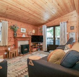 A living room with a television and fireplace at Watendlath in Keswick