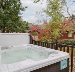 A hot tub on a wooden deck in an outdoor area at Costapacket in Windermere