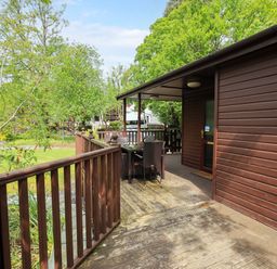 An outdoor deck area with a table and chairs at Costapacket in Grasmere 12, White Cross Bay near Windermere