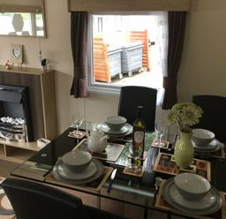 a dining area with a glass table set for four at Waterside, Paignton - Holiday Accommodation 10036, Paignton