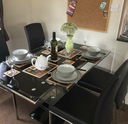 a dining table set with bowls and cutlery at Waterside, Paignton - Holiday Accommodation 10036, Paignton