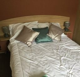 a bed with pillows and bedside lamps in a room at Waterside, Paignton - Holiday Accommodation 10036, Paignton
