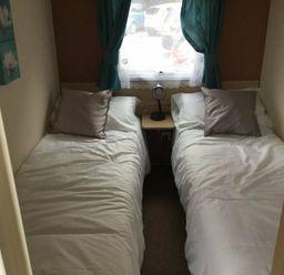 a bedroom with two single beds and a bedside table at Waterside, Paignton - Holiday Accommodation 10036, Paignton