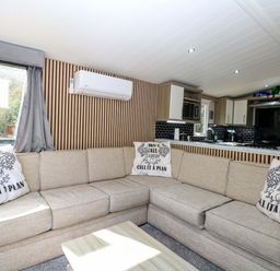 A living room with a sofa and coffee table at Wild Duck Holiday Park in Belton, Norfolk