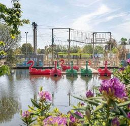a lake with pedal boats and a ropes course area at Hafan y Mor Haven - Holiday Accommodation 11370 Pwllheli