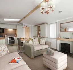 a living room with a sofa, dining area, and kitchen at Perran Sands - Holiday Accommodation 12174 in Perranporth