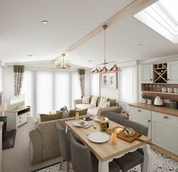 a living room and dining area with a table set for meals at Perran Sands - Holiday Accommodation 12174 Perranporth