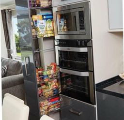 a modern refrigerator with glass-fronted compartments and meals in boxes at Ocean Edge Leisure Park - Holiday Accommodation 1317, Heysham