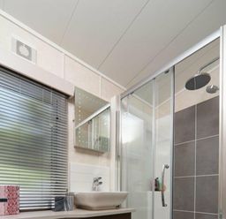 a bathroom with a shower, sink, mirror, and window at Ocean Edge Leisure Park - Holiday Accommodation 1317, Heysham