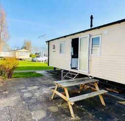 a caravan with a picnic table outside at Butlins Minehead - Holiday Accommodation 13288 in Minehead