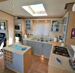 a kitchen with cabinets and appliances at Perran Sands - Holiday Accommodation 15012 in Perranporth