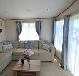 a living room with a sectional sofa and a coffee table at Perran Sands - Holiday Accommodation 15598 in Perranporth