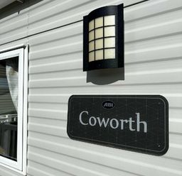 a wall sign with the name Coworth and a light fixture at Newquay Bay Resort - Holiday Accommodation 15978 in Newquay