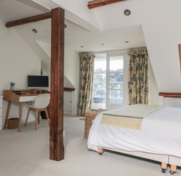 A bedroom with a desk and computer at Fastnet at Nonsuch House Kingswear, Devon