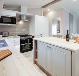 a kitchen with an island and appliances at Kelling Heath Holiday Park - Holiday Accommodation 16221, Holt