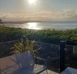A view of the sea and sun from a terrace at Hafan y Mor Haven - Holiday Accommodation 16251, Pwllheli