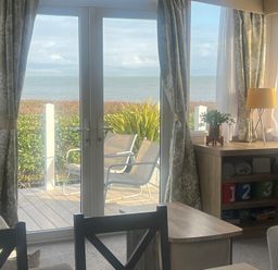 A living room with a view of the sea at Hafan y Mor Haven - Holiday Accommodation 16251 Pwllheli