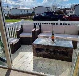 a terrace with seating and a table at Unity Holiday Resort - Holiday Accommodation 16507, Brean, Somerset, United Kingdom