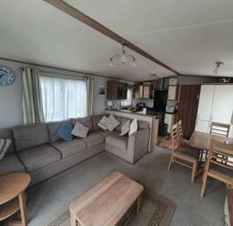 a living room with a sofa, coffee table, and dining area at Unity Holiday Resort - Holiday Accommodation 16507, Brean, Somerset, United Kingdom