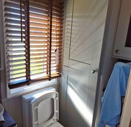 a bathroom with window blinds and a cabinet at Lakeland Leisure Park - Holiday Accommodation 16942 in Flookburgh