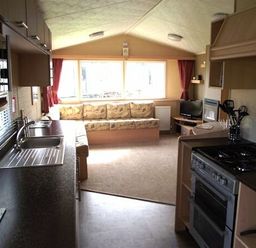 a kitchen and living area with a couch and television at Butlins Minehead - Holiday Accommodation 1700 in Minehead