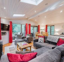 a living room with sofas, a television, and dining table at Kelling Heath Holiday Park - Holiday Accommodation 18691, Holt