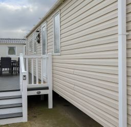 An outdoor area with a deck and seating at Whitehouse Leisure Park - Holiday Accommodation 19055, Towyn, Abergele
